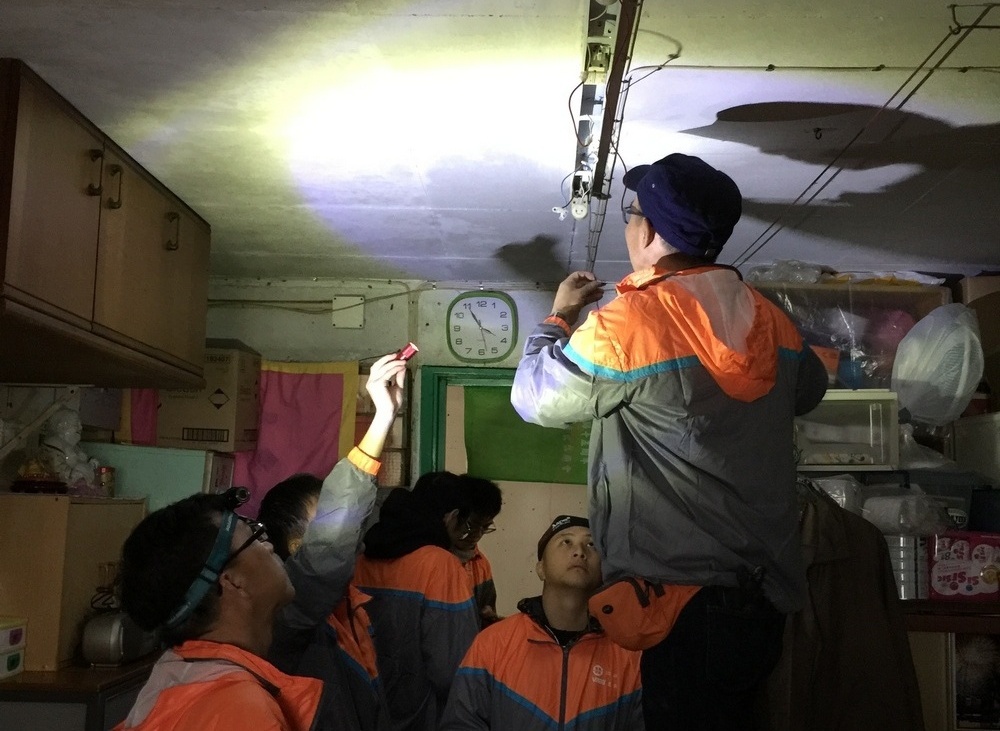 Grade A electrical workers installing new energy-efficient light fittings